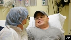In this Nov. 6, 2017 photo, Brian Madeux sits with his girlfriend Marcie Humphrey while waiting to receive the first human gene editing therapy at the UCSF Benioff Children's Hospital in Oakland, Calif. 