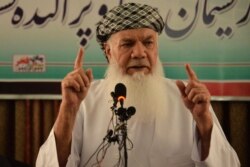 FILE - Afghan warlord and former mujahedeen leader Ismail Khan addresses a gathering at his house in Herat on July 9, 2021.