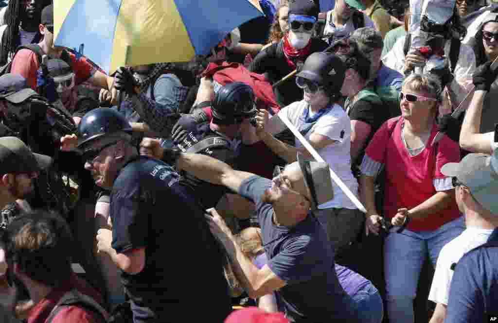 White nationalist demonstrators clash with counter demonstrators at the entrance to Lee Park in Charlottesville, Va., Aug. 12, 2017.