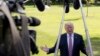 FILE - President Donald Trump speaks to the media as he walks across the South Lawn of the White House in Washington, Sept. 29, 2017.