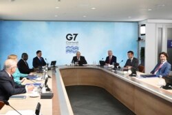 G-7 summit participants are seen during a session in Cornwall, England, June 12, 2021, with summit host, Britain's Prime Minister Boris Johnson, presiding.