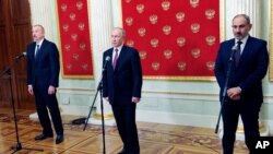 Russian President Vladimir Putin, center, Azerbaijan's President Ilham Aliyev, left, and Armenian Prime Minister Nikol Pashinyan speak to media after talks in Kremlin in Moscow, Russia, Jan. 11, 2021.