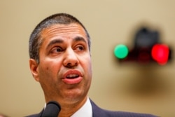 FILE - FCC Chairman Ajit Pai testifies at a House subcommittee hearing on Capitol Hill in Washington, Dec. 5, 2019.