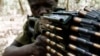 FILE - A Ugandan soldier tracking down Lord's Resistance Army (LRA) fugitive leaders takes position behind a machine gun at a forest bordering Central African Republic, South Sudan and Democratic Republic of Congo, near the Chinko River.