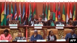 Mauritanian President Mohamed Ould Abdel Aziz, top center, and other officials sit with delegates at the plenary session of the 31st Ordinary Session of the Assembly of African Union (AU) Heads of State and Government, in Nouakchott, Mauritania, July 1, 2018.