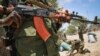 FILE - A fighter stands guard in the southern Somali port city of Kismayo.