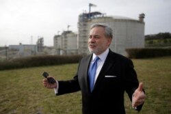 FILE - U.S. Secretary of Energy Dan Brouillette gestures during an interview after visiting the deepwater port in Sines, southern Portugal, Feb. 12, 2020.