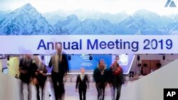 People walk up stairs at the congress center where the annual meeting of the World Economic Forum 2019, WEF, take place in Davos, Jan. 20, 2019. 