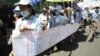 Cambodian protesters from Boueng Kak lake march with a banner displaying the thumb prints of fellow land owners who have been evicted from their homes, as they demand compensation, in Phnom Penh, Cambodia. 