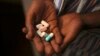 Nine-year-old Tumelo shows off antiretroviral (ARV) pills before taking his medication at Nkosi's Haven, south of Johannesburg, Nov. 28, 2014. 