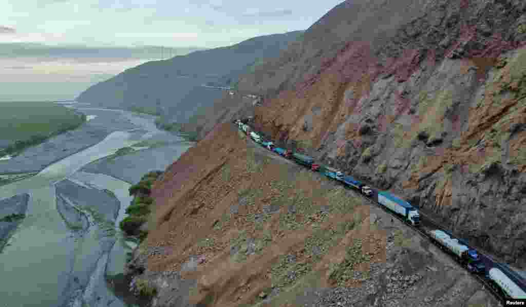 A drone image shows vehicles parked on a mountain road as small-scale miners halt traffic to demand the extension of a program that allows them to operate temporarily in Ocona, Peru, Nov. 27, 2024.