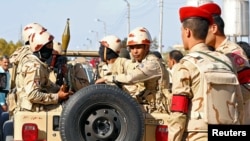 FILE - Military forces look on in North Sinai, Egypt, Dec. 1, 2017.