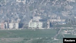Smoke erupts following a shell explosion in Bakhmut