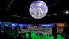 Para pengunjuk rasa memegang banner di dalam venue pada KTT Iklim COP26 U.N. di Glasgow, Skotlandia, 5 November 2021. (Foto: AP)