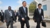 U.N. Secretary-General Ban Ki-moon, center, walks inside the heavily-protected airport complex during a visit to Mogadishu, Somalia, Oct. 29, 2014.