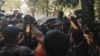 Reuters journalist Wa Lone is being taken back to jail at the end of the court session, Jan. 10, 2018, surrounded by members of the Burmese media. 