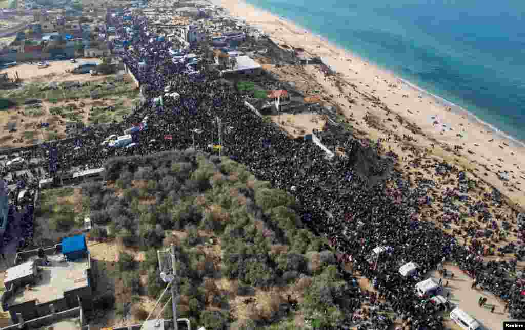 A drone view shows Palestinians waiting to be allowed to return to their homes in northern Gaza after they were displaced to the south at Israel's order during the war, in the central Gaza Strip.