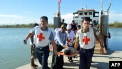 Injured people from Kyauk Tan village in Rathedaung township are carried on stretchers as they arrive in Rakhine state's capital Sittwe in western Myanmar, May 2, 2019.