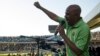 FILE - The Association of Mineworkers and Construction Union (AMCU) President Joseph Mathunjwa speaks to striking mine workers at the Royal Bafokeng Stadium in Rustenburg, June 23, 2014.