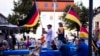 FILE - Supporters of the far-right Alternative for Germany party, or AfD, hold German national flags as they attend an election campaign rally of the party for upcoming state elections, in Suhl, Germany, Aug. 13, 2024.