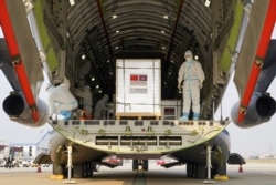 A shipment of 600,000 doses of COVID-19 vaccines donated by China arrives at the Phnom Penh International Airport, Feb. 15, 2021.