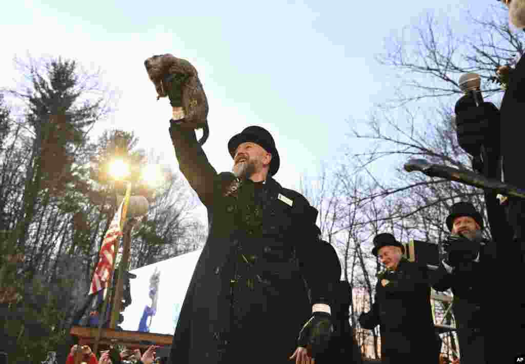 Groundhog Club handler A.J. Dereume holds Punxsutawney Phil, the weather prognosticating groundhog, during the 139th celebration of Groundhog Day on Gobbler's Knob in Punxsutawney, Pennsylvania.