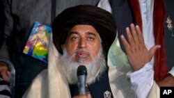 FILE - Khadim Hussain Rizvi, founder of Tehreek-e-Labbaik Pakistan, gestures during a news conference in Islamabad, Pakistan, Nov. 26, 2017.