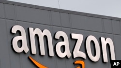 FILE - A sign is seen on the facade of an Amazon fulfillment center, in New York City, March 19, 2020. Most of Amazon's 60 plus fulfillment centers in India are shut and the U.S.-based company is in talks with state authorities to try to reopen them.
