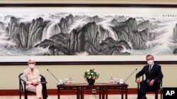 In this photo provided by the U.S. Department of State, U.S. Deputy Secretary of State Wendy Sherman, left, and Chinese Foreign Minister Wang Yi sit together in Tianjin, China, July 26, 2021. 