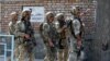 FILE - Afghan security forces arrive at the site of a suicide attack in Kabul, Afghanistan, March 21, 2018.