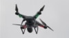 FILE - A drone hovers over the scene of an explosion that leveled two apartment buildings in the East Harlem neighborhood of New York, New York, March 12, 2014.