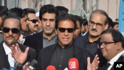 FILE - Pakistan's opposition leader, Imran Khan, center, speaks to reporters in Islamabad, Jan. 2, 2018. Khan criticized U.S. President Donald Trump on Jan. 3 as "ignorant and ungrateful" after the U.S. leader accused Pakistan of harboring terrorists. 