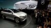 FILE - In this April 20, 2014 file photo, visitors look at the latest model from Mercedes at an auto show in Beijing. Nearly half of foreign companies in China feel singled out in a wave of anti-monopoly and other investigations, and a growing number are deciding not to expand their investments.