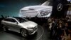 FILE - In this April 20, 2014 file photo, visitors look at the latest model from Mercedes at an auto show in Beijing. Nearly half of foreign companies in China feel singled out in a wave of anti-monopoly and other investigations, and a growing number are deciding not to expand their investments, the American Chamber of Commerce in China said, Feb. 11, 2015.