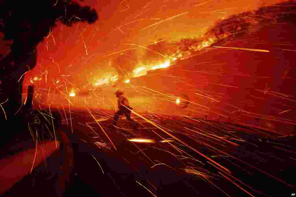 Firefighters battle the Franklin Fire in Malibu, California. Thousands of Southern California residents are under evacuation orders and warnings as firefighters battle a wind-driven wildfire in Malibu. The flames burned near seaside mansions and Pepperdine University, where students sheltering at the school’s library watched as the blaze intensified.