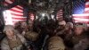 U.S. Marines are seen on board a helicopter at Kandahar air base upon the end of operations for the Marines and British combat troops in Helmand province, Oct. 27, 2014. 