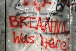 Graffiti is show on the damaged base of a Confederate memorial that was removed overnight in Birmingham, Ala., on June 2, 2020.
