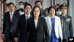 Taiwanese President Tsai Ing-wen, center, walks ahead of Vice-President Lai Ching-te, left of her, as they attend an inauguration ceremony in Taipei, Taiwan, May 20, 2020. 