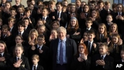 The Chulmleigh College school choir sings and signs 'A Lovely Day' as Britain's Prime Minister and Conservative Party leader, Boris Johnson visit in Chulmleigh, England, Nov. 28, 2019, ahead of the general election on Dec. 12. 