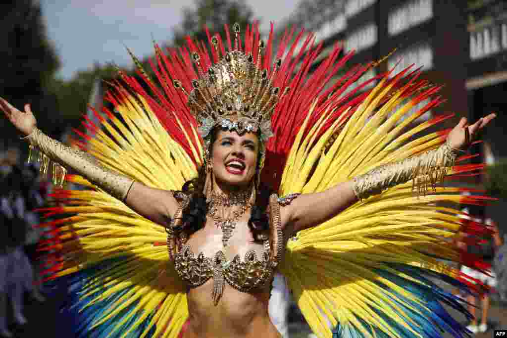 A carnival performer poses on the main Parade day of the Notting Hill Carnival in west London. Nearly one million people are expected in the streets of Notting Hill to celebrate Caribbean culture at a carnival considered the largest street demonstration in Europe.