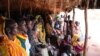 Refugees take shelter from the scorching sun as they wait to register at Yida refugee camp in South Sudan's Upper Nile, August 2012. (VOA - H. McNeish)