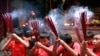 FILE - Indonesian ethnic Chinese children pray at a temple in the China Town in Jakarta, Indonesia.