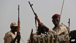 FILE - Sudanese soldiers from the Rapid Support Forces unit, led by Gen. Mohammed Hamdan Dagalo, the deputy head of the military council, secure the area where Dagalo attends a military-backed tribe's rally, in the East Nile province, Sudan, June 22, 2019. 
