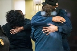 People embrace after learning that their loved one was safe after a mass shooting at the FedEx facility in Indianapolis, Indiana, April 16, 2021. (Mykal McEldowney/IndyStar/USA Today Network via Reuters)