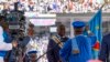 A Constitutional Court judge hands the national flag to Congolese President Felix Tshisekedi after he took the oath of office at his inauguration ceremony in Kinshasa on Jan. 20, 2024.