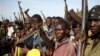 FILE - Jikany Nuer White Army fighters hold their weapons in Upper Nile State, February 2014.