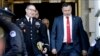 FILE - Lt. Col. Alexander Vindman, left, walks with his twin brother, Yevgeny Vindman, after testifying before the House Intelligence Committee, on Capitol Hill in Washington, Nov. 19, 2019.