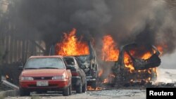 Beberapa mobil terbakar akibat ledakan saat kawanan bersenjata menyerang kantor "Save the Children" di Jalalabad, Afghanistan, Rabu (24/1). 