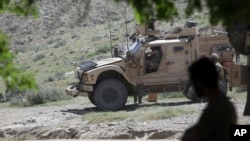 FILE - U.S. forces and Afghan commandos are seen in Asad Khil village in the Achin district of Jalalabad, Nangarhar province, Afghanistan, April 17, 2017.