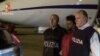 This handout picture released by the Italian police (Polizia di Stato), on June 8, 2016 shows Medhanie Yehdego Mered, 35, an Eritrean suspected of controlling a migrant trafficking network, escorted by policemen upon his extradition from Sudan to Italy late on June 6, 2016.
